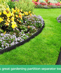 2 Inch Landscape Edging Border Kit With 100 Anchoring Spikes installed in a garden, separating flower bed and grass, black flexible edge