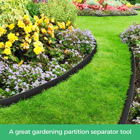 2 Inch Landscape Edging Border Kit With 100 Anchoring Spikes installed in a garden, separating flower bed and grass, black flexible edge