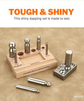 Heavy Duty Steel 8 Hole Dapping Block And 8 Matching Punch Set on wooden stand with size marked handles