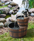 Go-To Wood Freestanding Two Tier Waterfall Barrel Fountain With Electric Pump For Garden Decor in a garden setting