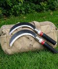 Two Piece Hand Sickle Garden Tool Set No Nonsense Heavy Duty Manganese Steel Weed Cutter resting on a canvas bag