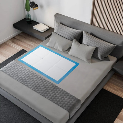 Super Absorbent Disposable Underpads And Incontinence Bed Pads 23 X 36 Inch on a bed, designed to protect against moisture.