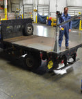 Smooth Operator DC Powered Jib Crane With Galvanized Build And Telescoping Boom Handles 1500 Pounds Easily For Real Workshops Using 360 Swivel Design, hoisting a barrel on a truck.