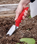 Heavy Duty Garden Trowel For Everyday Digging And Planting used in vegetable garden for precise digging in raised bed.
