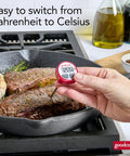 Must Have Everyday Digital Food Thermometer With Stainless Steel Probe Instant Read For Quick Accurate Temps In Fahrenheit Or Celsius, Easy To Read LCD Display, Includes Storage Sleeve, Red being used to measure steak temperature