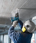 Worker using Two Cutter Head Three Quarter Inch By Twenty Four Inch SDS Plus Bulldog Rotary Hammer Bit for ceiling drilling.