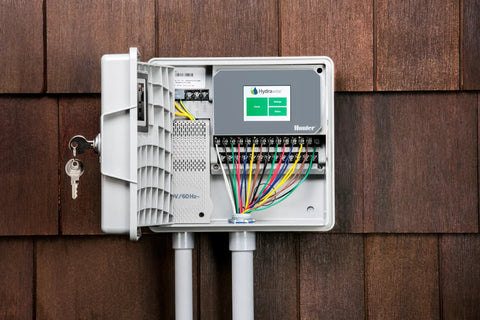 Hydrawise Pro HC 24 Station WiFi Smart Sprinkler Controller for Outdoor Irrigation Timer mounted on wood siding