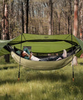 4 In 1 Camping Hammock Tent With Rain Fly And Mosquito Net For Adults in forest with person relaxing inside