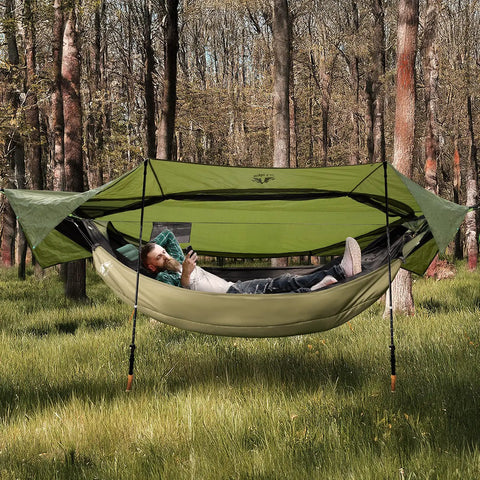 4 In 1 Camping Hammock Tent With Rain Fly And Mosquito Net For Adults in forest with person relaxing inside