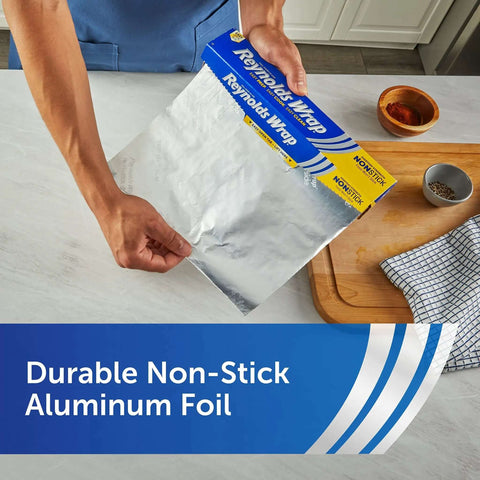 Person holding nonstick aluminum foil for easy cooking and mess free cleanup, perfect for casseroles and roasts, 130 sq ft, 12 inch wide.