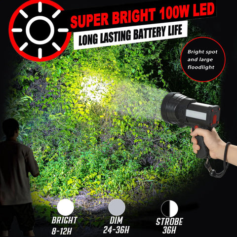 Person using Rechargeable 100000 Lumen Spotlight With COB Flood Light, illuminating a forest area at night with bright beam.
