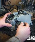 Person using Electric Twist Drill Bit Sharpener For 3/32 To 1/2 Inch Bits, Pro Grade High Speed Portable Sharpening tool on workbench.