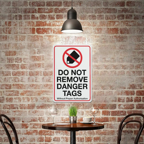 Industrial Grade Aluminum Safety Sign 8x12 Inch No Tampering Lockout Caution Plaque on brick wall in dimly lit space