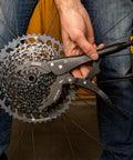 Vise Whip II Cassette Removal Tool For Bikes gripping a cassette, showcasing heat treated steel and easy release jaws.