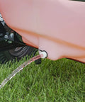 Water flowing from a 60-Gallon Tow Behind Sprayer With 60 Gallon Capacity, 4 GPM Diaphragm Pump onto grass during lawn care