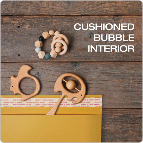 Bubble Mailers 8.5 X 11 Inch Kraft Padded Envelopes With Self Seal Closure cushioning toys on wooden surface.