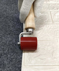 Side view of welding handheld seam roller with wooden handle and red 40mm silicone roller