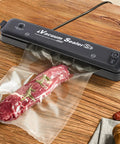 Single-Ply Vacuum Sealer Bags 6x10 Inch Quart Size used in food storage with a cut of meat inside, wood table background