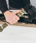 Person holding axe wrapped with Self Cling Camouflage Fabric Wrap For Gear And Knives, Reusable And Washable, No Sticky Residue