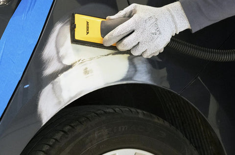 Using Hands On 2.75 Inch By 8 Inch Sanding Block Kit With Hook And Loop System on car surface for dust-controlled sanding