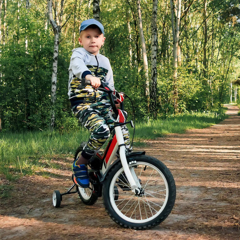 Child riding a bike with training wheels in a forest, using Two Pack Heavy Duty Bike Tubes For 18 Inch Rims 18x1.75 To 18x2.25 With AV Schrader Valve 32mm 45/57-355