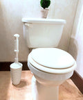 Heavy Duty Toilet Plunger Kit With Smart Air Relief Valve And Spacious Tall Bucket Caddy Effortlessly Knocks Out Stubborn Drain Clogs Fast No Hassle Cleanup For Quick Home Plumbing Fixes In White next to a toilet in a bathroom.