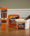 Interior Wood Filler For Holes Dents Scratches And Gouges In Wood Wallboard Molding And Painted Surfaces 16 Oz container on floor