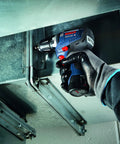 Person using 12V Max EC Brushless 3/8 Inch Drill Driver Bare Tool with Pro Torque 300 in-lbs in tight space, wearing gloves.
