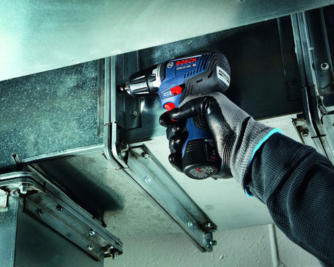Person using 12V Max EC Brushless 3/8 Inch Drill Driver Bare Tool with Pro Torque 300 in-lbs in tight space, wearing gloves.