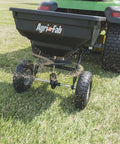Tow Behind Broadcast Spreader With 85 Lb Capacity For Lawns, 10 Foot Spread, Covers Up To 14,000 Sq Ft Per One Quarter Acre attached to tractor