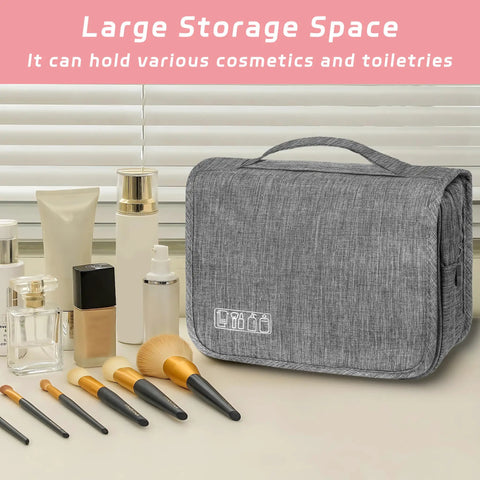 Compact Hanging Toiletry Bag With Hook Waterproof Travel Organizer for men and women, gray, on table with cosmetics
