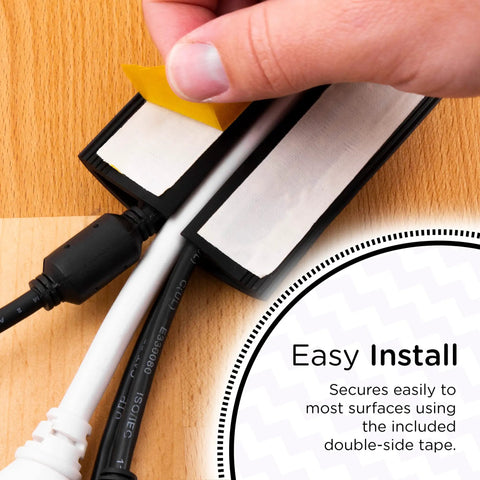 Hand applying tape to 10Ft Floor Cord Cover Cable Protector For Home And Office Hide Extension Cords Prevent Trip Hazards