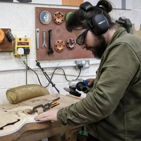 Man wearing Noise Isolating Bluetooth Earmuffs for Worksite, Boss Level Comfort, memory foam, 24 dB NRR noise reduction, woodworking