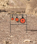 Auto Reset AR500 Steel Shooting Target With Spinner Mechanism in rocky terrain, 1.5", 2", 3.5" orange targets.