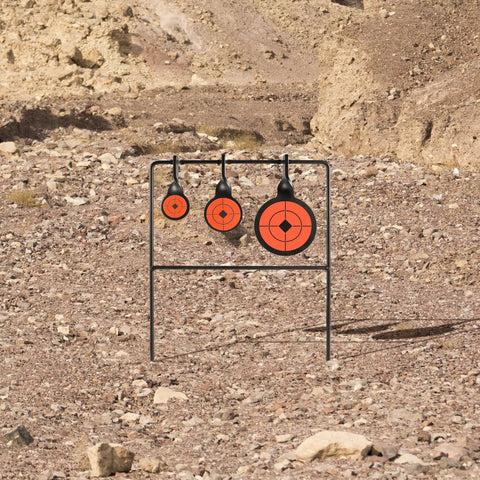 Auto Reset AR500 Steel Shooting Target With Spinner Mechanism in rocky terrain, 1.5", 2", 3.5" orange targets.