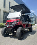 Top Tier Four Seater Electric Golf Cart Built With A Solid Front Bumper And Aggressive Off Road Tires Including HD LED Smart Dashboard. Red model on street.
