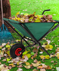 Folding Wheelbarrow With Collapsible Garden Cart For Lawn Care, 80Lb Capacity, filled with leaves near a rake on grass