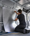 Man installing Top Shelf Reflective Insulation Bubble Wrap Roll Thermal Barrier Foil on vehicle interior for temperature control.