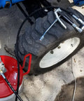 Pneumatic Grease Pump For 25-50Lb Pails, 40:1 Ratio Up To 4,000 PSI connected to tire for efficient lubrication.