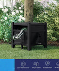 Hideaway Garden Hose Box With Reel 100Ft Durable Resin Outdoor Storage next to tree in backyard garden.