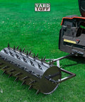 36 Inch Wide Lawn Aerator Roller With 78 Steel Spikes And 24 Gallon Water Holder attached to a mower on grass.