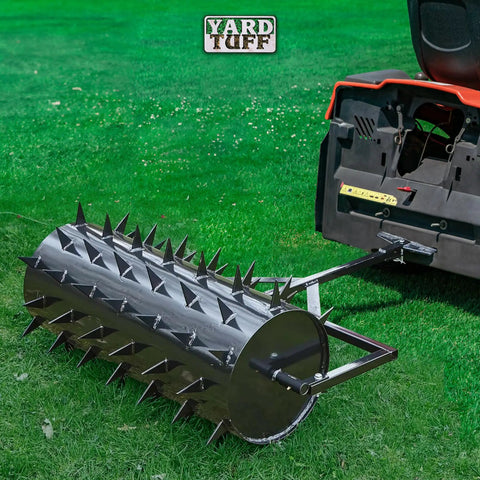 36 Inch Wide Lawn Aerator Roller With 78 Steel Spikes And 24 Gallon Water Holder attached to a mower on grass.