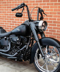 Harley-Davidson motorcycle featuring Beefy Heavy Industry Motorcycle Grips With End Caps For Electronic Throttle Control On Harley-Davidson 2008 To 2019 Satin Black 1 Pair Knurled Pads For Extra Grip And Vibration Dampening On Long Rides parked against a brick wall.