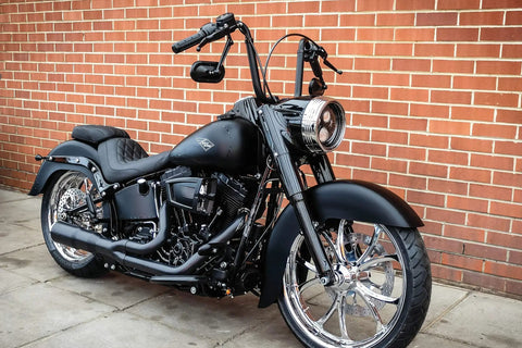 Harley-Davidson motorcycle featuring Beefy Heavy Industry Motorcycle Grips With End Caps For Electronic Throttle Control On Harley-Davidson 2008 To 2019 Satin Black 1 Pair Knurled Pads For Extra Grip And Vibration Dampening On Long Rides parked against a brick wall.
