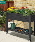Elevated Garden Bed With Wheels And Storage Shelf For Outdoor Use Plastic Planter Box With Drain Plug Central Divider And Water Level Float System For Precise Moisture Control For Plants Vegetables Flowers And Herbs Black, front view