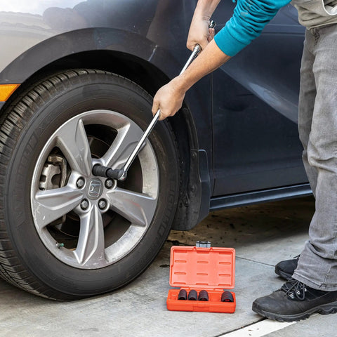 Mechanic using Six Piece Half Inch Drive Impact Socket Set For Any Job With Ten SAE And Metric Sizes on car wheel lug nuts