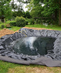 No Stress Heavy Duty Nonwoven Geotextile Underlayment 15 X 15 Feet Weed Barrier Pond Liner around a constructed pond in a garden.