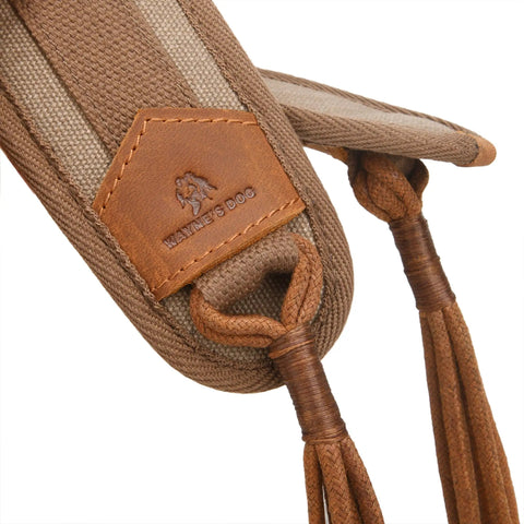 Close-up of brown canvas bird game carrier with leather trim and waxed cord loops.