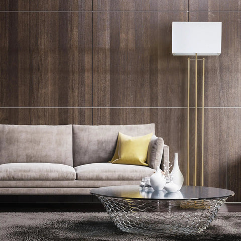 SoHo Floor Lamp 62 Inch In Matte Brass With White Linen Shade next to a beige sofa in a modern living room.