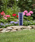 5 Inch Capacity Magnifying Rain Gauge With Easy To Read White Numbers, Acrylic Weather-Resistant Build, in a garden setting.